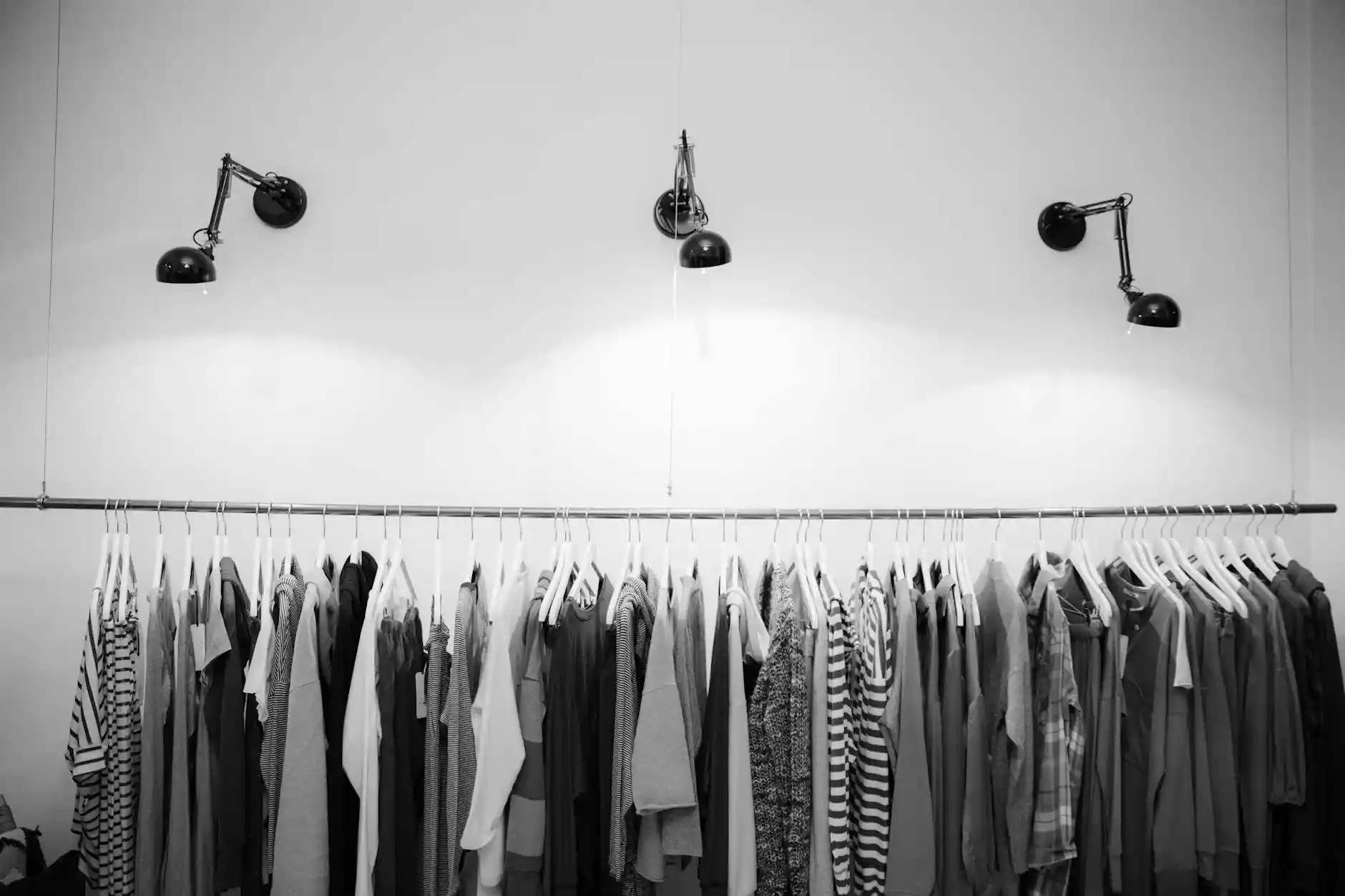 <a href="https://www.pexels.com/photo/grayscale-photography-of-assorted-shirts-hanged-on-clothes-rack-1884584/">Photo by Tembela Bohle on Pexels</a>